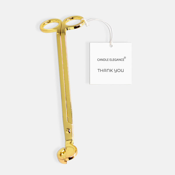 A gold metal candle tongs with a white hangtag that reads 'CANDLE ELEGANCE THANK YOU', set against a light gray background.