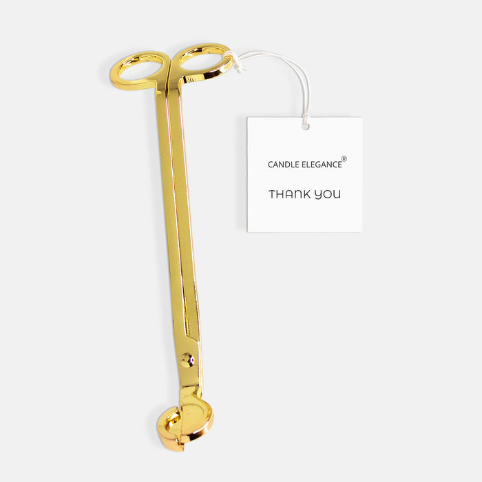 A gold metal candle tongs with a white hangtag that reads 'CANDLE ELEGANCE THANK YOU', set against a light gray background.