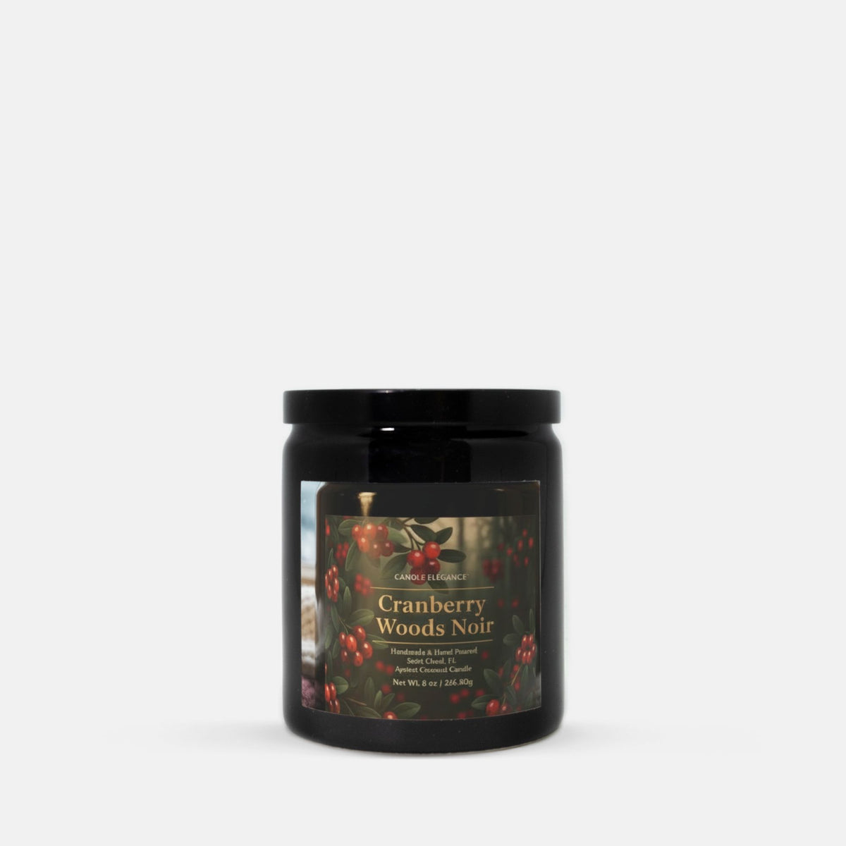 A black glass jar candle with a black lid and a front label reading 'Cranberry Woods Noir' by Candle Elegance, shown on a clean light gray background.