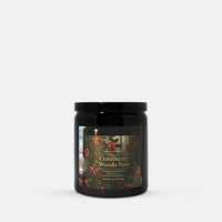 A black glass jar candle with a black lid and a front label reading 'Cranberry Woods Noir' by Candle Elegance, shown on a clean light gray background.
