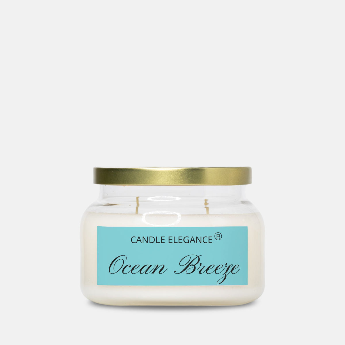 A jar candle with white wax, a gold metal lid, and a light blue label reading 'CANDLE ELEGANCE' and 'Ocean Breeze' on a light gray background.