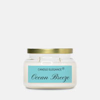 A jar candle with white wax, a gold metal lid, and a light blue label reading 'CANDLE ELEGANCE' and 'Ocean Breeze' on a light gray background.