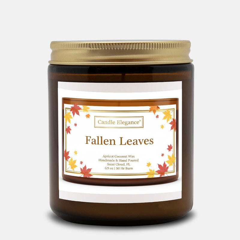 A dark amber glass jar candle with a gold metal lid and a white label reading 'Candle Elegance' and 'Fallen Leaves' with autumn leaf illustrations, on a light gray background.