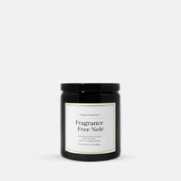 A black glass jar candle with a white label reading 'Fragrance Free Noir' by Candle Elegance, centered on a light gray background.