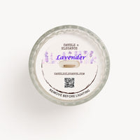 Top-down view of a round dust cover, textured glass jar candle with a white wax surface and a printed label reading 'Candle Elegance', 'Lavender', and 'Remove Before Lighting'.