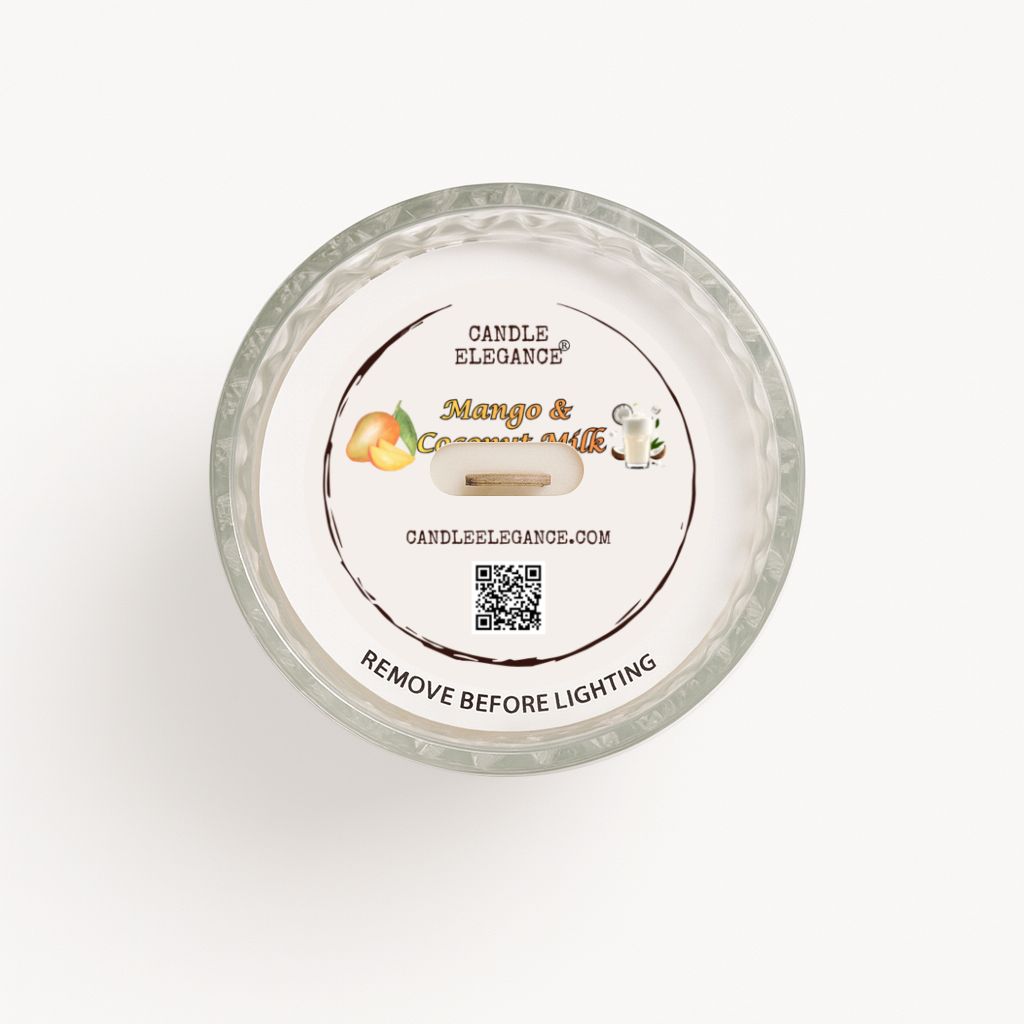 Top-down view of a Candle Elegance dusto cover, 'Mango & Coconut Butter' scented candle in a clear textured glass jar, showing the white wax surface and printed label.