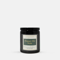 A black glass jar candle with a black lid and a cream label reading 'Candle Elegance' and 'Fraser Fir Noir', centered on a light gray background.