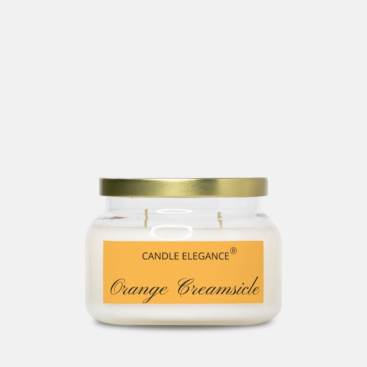 A jar candle with creamy off-white wax, a gold metal lid, and a yellow-orange label reading 'CANDLE ELEGANCE' and 'Orange Creamsicle' on a light gray background.