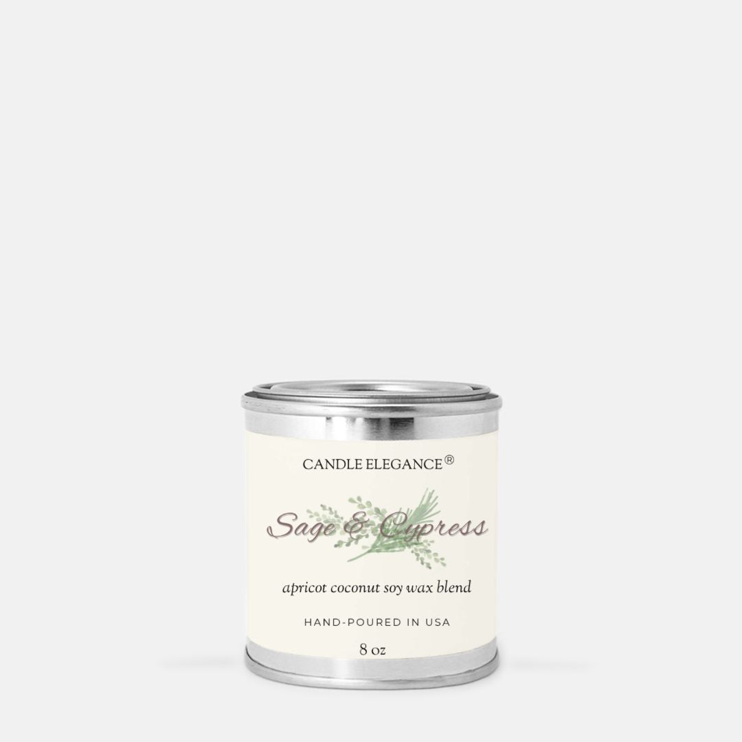 A small cylindrical metal candle tin with a cream label reading 'Candle Elegance Sage & Cypress' on a light gray background.