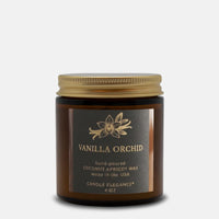 A 4 oz hand-poured coconut apricot wax candle by Candle Elegance in a dark amber glass jar with a gold metal lid and a black label featuring gold lettering that reads 'VANILLA ORCHID'.
