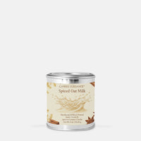 A single candle tin labeled CANDLE ELEGANCE Spiced Oat Milk, shown on a plain light gray background.