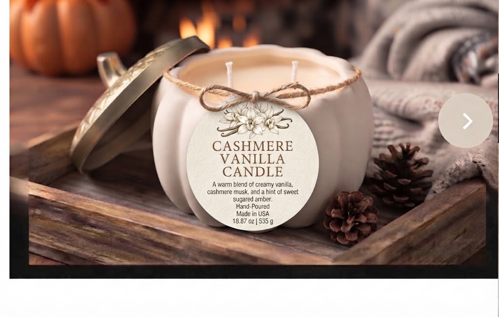 A pumpkin-shaped candle with its lid leaning beside it on a rustic wooden tray. The candle is wrapped with a twine bow and has a round paper label that reads 'CASHMERE VANILLA CANDLE.