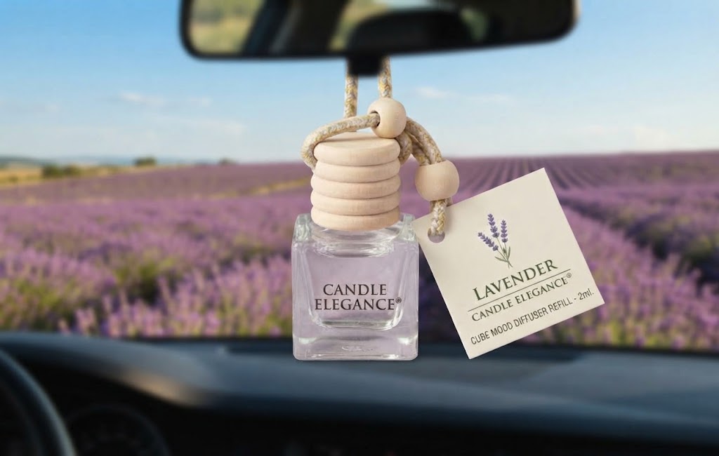 A lavender scented car diffuser bottle with a wooden bead top and a hanging tag, displayed on a car dashboard with a blurred lavender field in the background.
