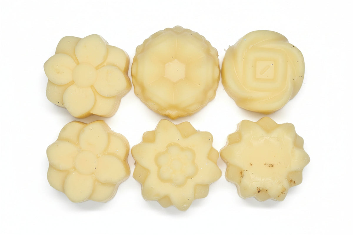 Six floral-shaped cookies on a white surface