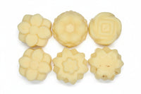 Six floral-shaped cookies on a white surface
