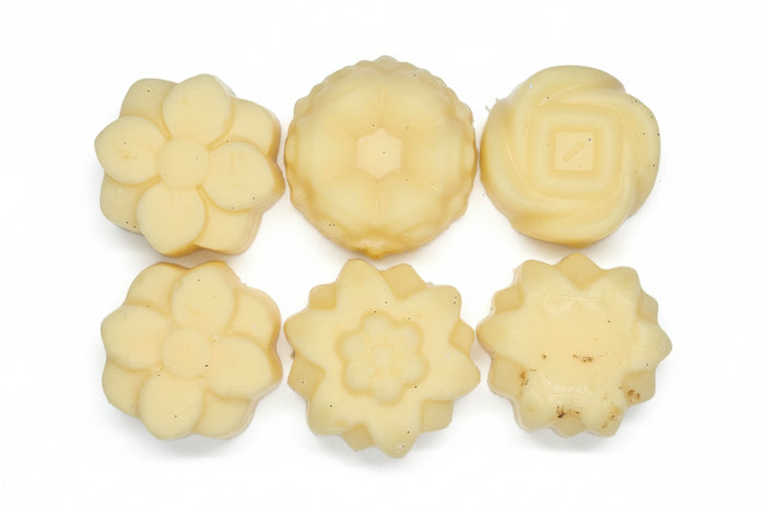 Six floral-shaped cookies on a white surface