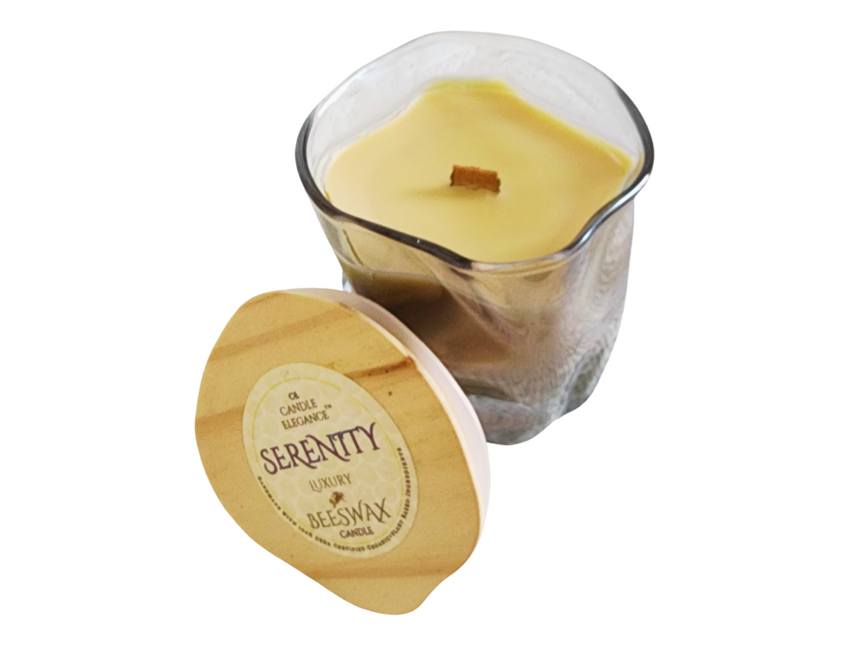 Scented candle with wooden lid labeled 'Serenity' on a white background