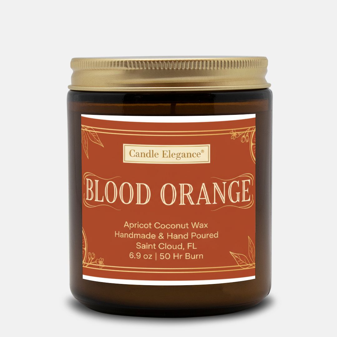 An amber glass jar candle with a gold screw-top lid and a terracotta-colored label reading 'Candle Elegance BLOOD ORANGE' on a light gray background.