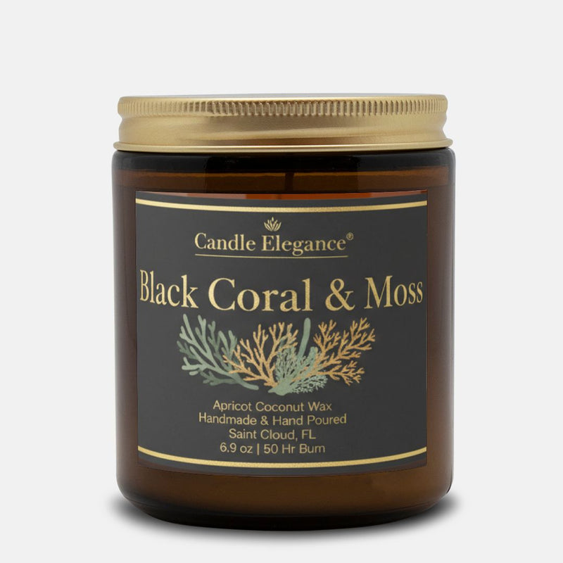 A jar candle from Candle Elegance labeled 'Black Coral & Moss' with apricot coconut wax, shown on a light gray background. The candle is in an amber glass jar with a gold lid and a black label featuring gold text and botanical illustrations.