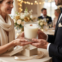Cashmere Vanilla candle being handed over as a wedding gift by someone wearing an ivory cashmere scarf