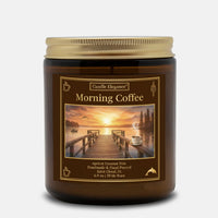 A Candle Elegance 'Morning Coffee' scented candle in a dark amber glass jar with a gold metal lid, set against a light gray background.