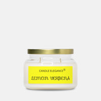 A Candle Elegance 'Lemon Verbena' scented candle in a clear glass jar with a gold metal lid and a bright yellow label, set against a plain light gray background.