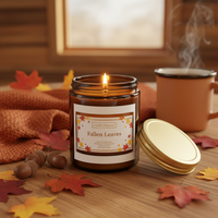 Fallen Leaves – Cabin, Lid Removed A dark amber glass jar candle with a gold metal lid and a white label reading 'Candle Elegance' and 'Fallen Leaves' with autumn leaf illustration in the background.
