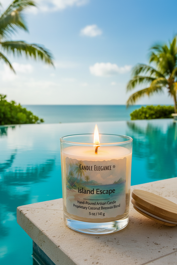 A lit Candle Elegance Island Escape scented candle in a clear glass jar sits on a stone ledge beside its wooden lid, with a tropical infinity pool and ocean in the background.