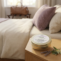 Lavender & Sage travel candle in a serene guest room