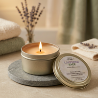 Lit Lavender & Sage travel candle on a spa vanity