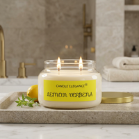 Lit Lemon Verbena candle on a luxe marble bath counter