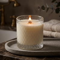 Lit Spa Day candle on a moody luxe bath counter