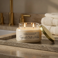 Lit Spiced Oat Milk candle on a luxe travertine bath counter