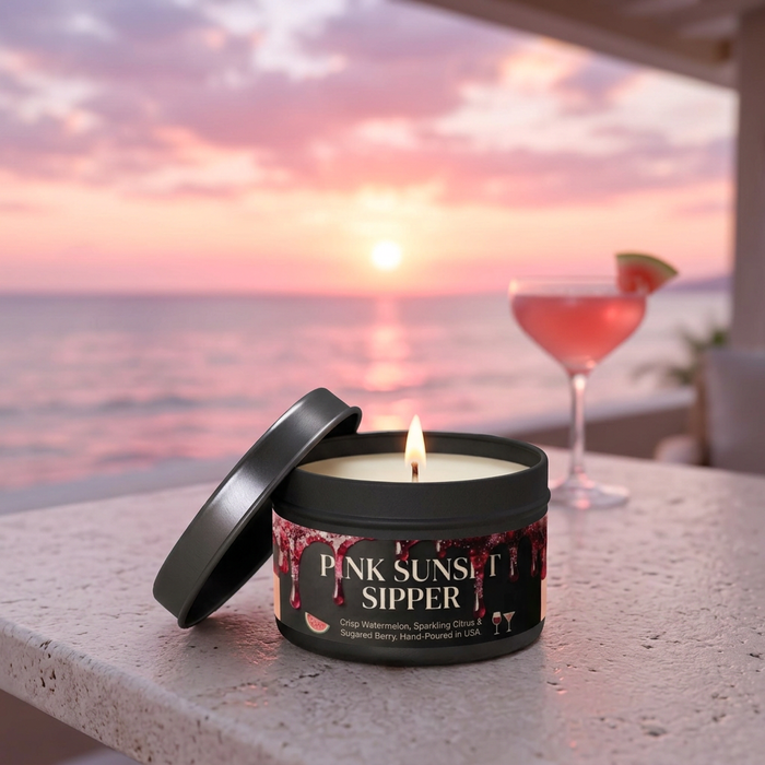 Pink Sunset Sipper candle against a pink ocean sunset