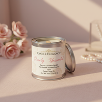 A Candle Elegance Purely Unscented candle in a silver metal tin with its lid leaning beside it, set on a soft blush surface with blurred pink roses and a glass vessel in the background.