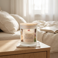 Solstice candle in a serene linen bedroom