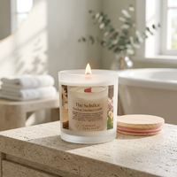 Solstice candle on a travertine spa bathroom vanity