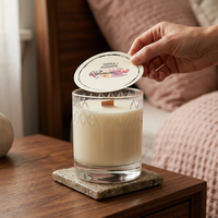 Someone lifting the dust cover off the Bohemian Rose candle