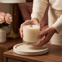 Someone placing an unlit Bohemian Rose candle on a walnut nightstand
