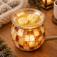 Two partly melting floral melts in a mosaic electric warmer