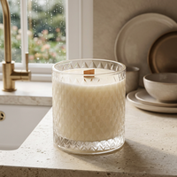 Unlit Bare Essence candle beside a farmhouse kitchen sink