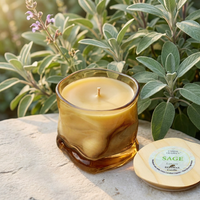 Unlit Sage candle with its lid beside it in a sage garden