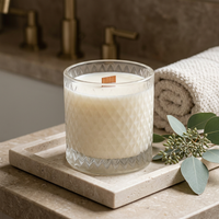 Unlit Spa Day candle in a luxe spa setting with a short wooden wick